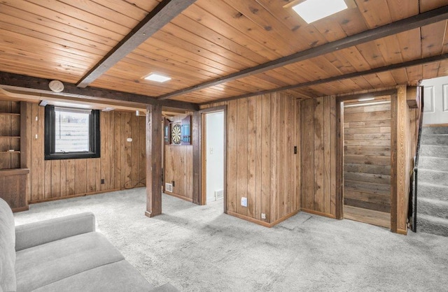 interior space with wood ceiling, light colored carpet, wood walls, and stairway