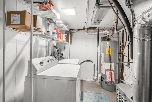 laundry room featuring laundry area, gas water heater, and washing machine and dryer