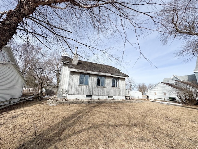 view of front of home featuring a front lawn, fence, and a chimney