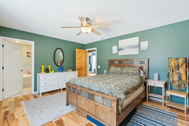 bedroom with ceiling fan, a textured ceiling, ensuite bathroom, and wood finished floors