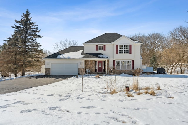 traditional-style home with a garage and stone siding