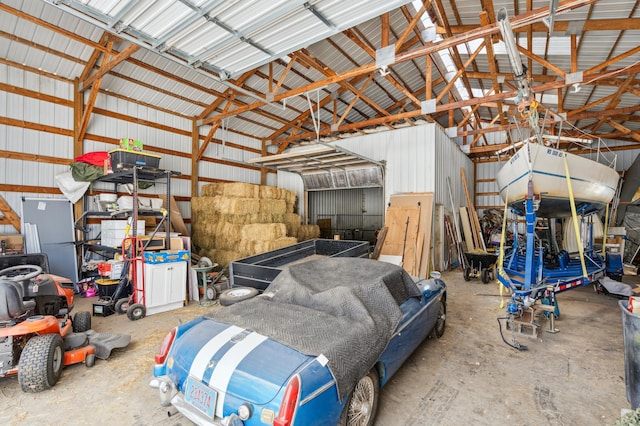 garage with freestanding refrigerator and metal wall