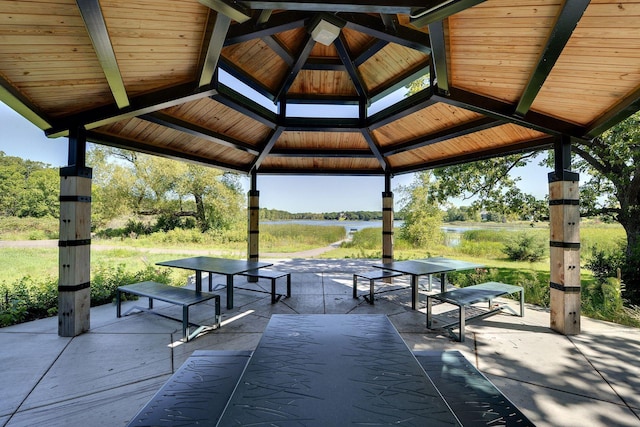 view of community featuring a gazebo, a water view, and a patio area