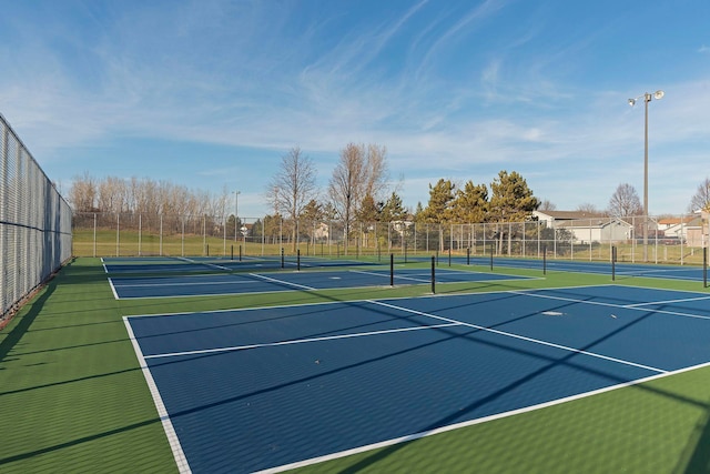 view of sport court featuring fence