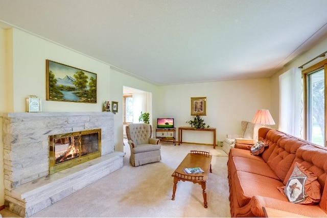 carpeted living room featuring plenty of natural light and a fireplace