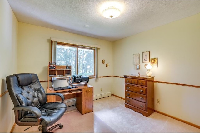 office featuring a baseboard heating unit, light colored carpet, baseboards, and a textured ceiling