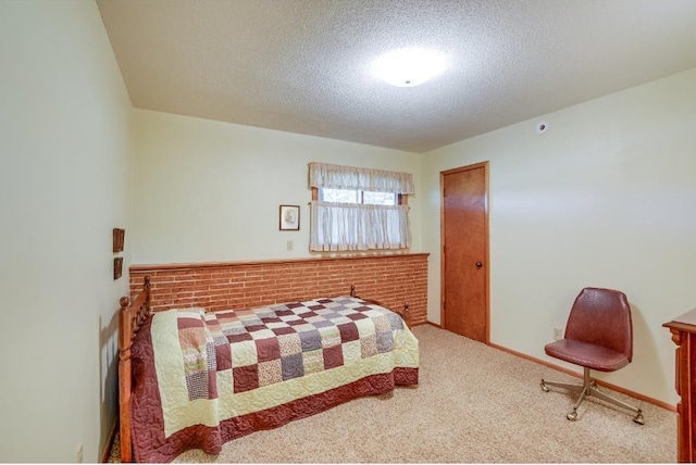 bedroom with a textured ceiling and carpet