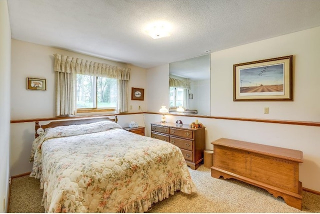 bedroom with a textured ceiling and carpet floors