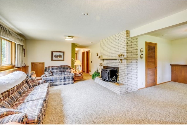 living area featuring beam ceiling, a textured ceiling, carpet flooring, baseboards, and a wood stove