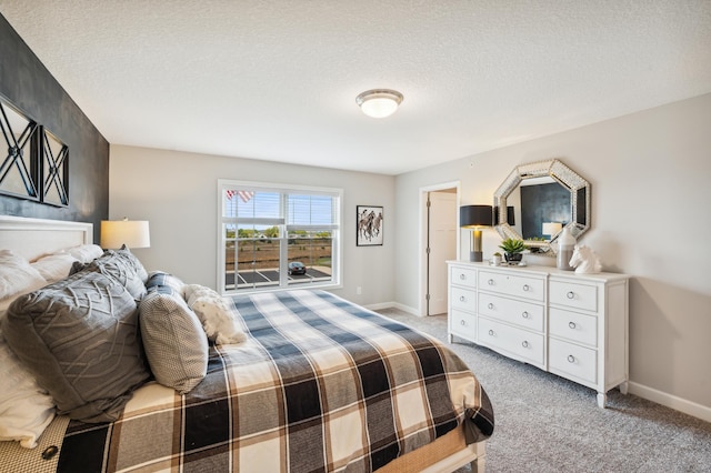 bedroom with light carpet and a textured ceiling