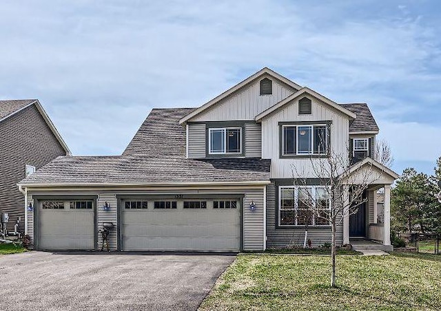 view of front of home with a front lawn and a garage