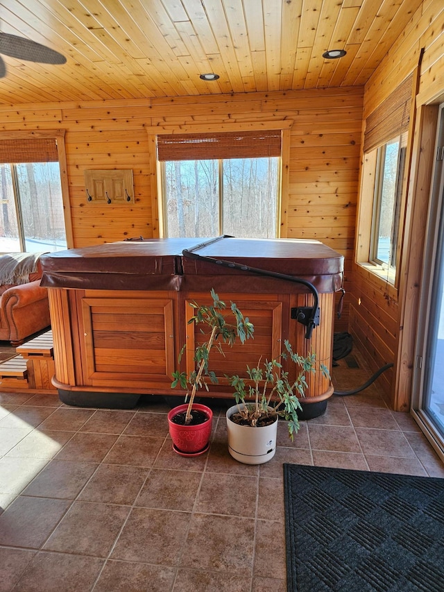 interior space with wooden walls, wooden ceiling, and plenty of natural light