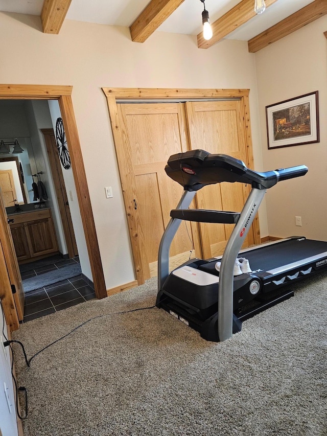 exercise room featuring dark tile patterned flooring