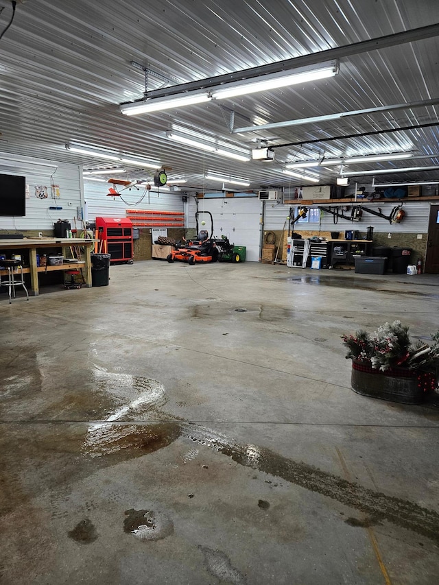 garage with a workshop area and a garage door opener