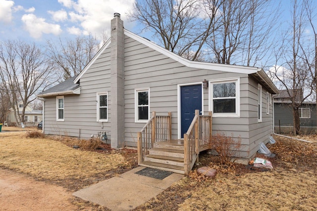 bungalow featuring a chimney