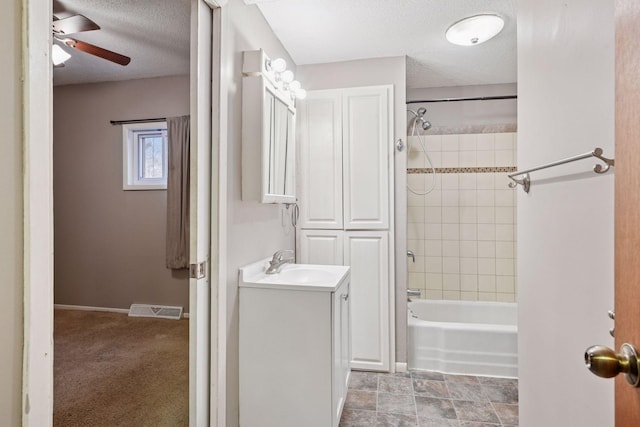 full bath featuring shower / bathtub combination, visible vents, a ceiling fan, a textured ceiling, and vanity