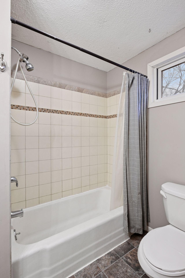 full bath with shower / bathtub combination with curtain, toilet, and a textured ceiling