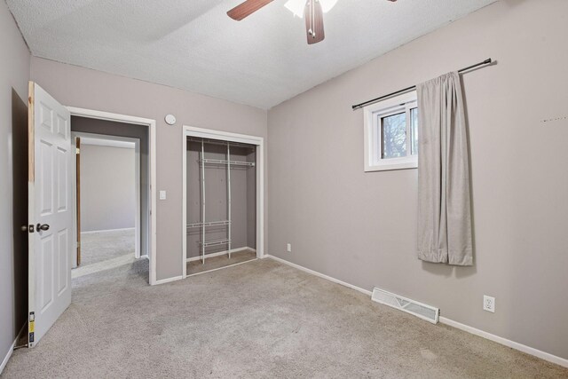 unfurnished bedroom featuring a closet, carpet, visible vents, and baseboards