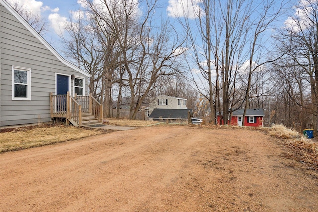 view of yard with dirt driveway