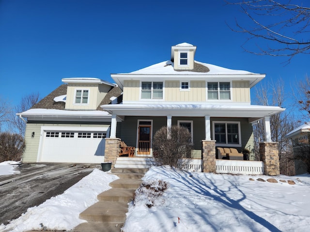 view of front of home with covered porch and a garage