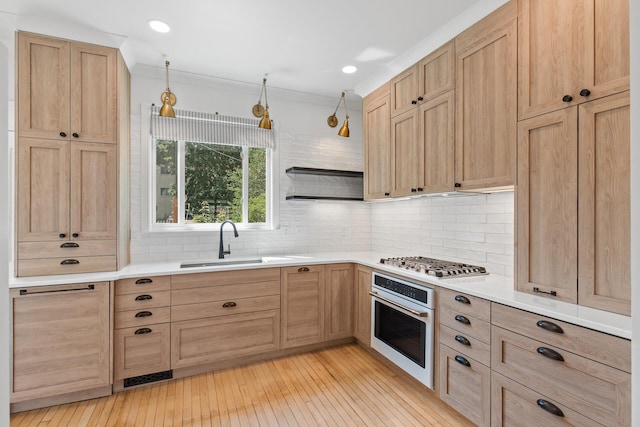 kitchen with oven, stainless steel gas cooktop, light countertops, open shelves, and pendant lighting