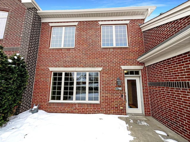 view of snow covered property entrance