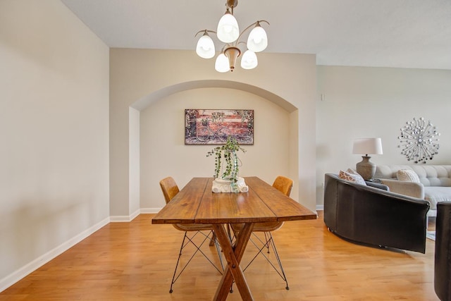 dining space featuring an inviting chandelier and hardwood / wood-style floors