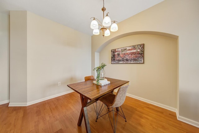 dining area featuring a chandelier and wood-type flooring