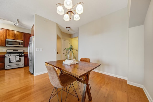 dining room featuring a chandelier and light hardwood / wood-style floors