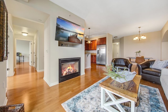 living room with light hardwood / wood-style flooring and a chandelier