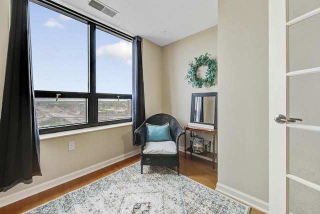 sitting room with hardwood / wood-style floors