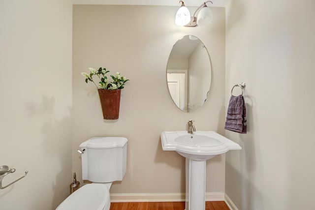 bathroom with toilet and wood-type flooring