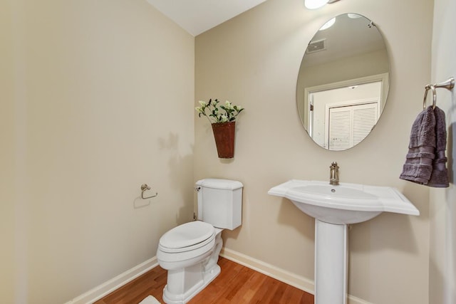 bathroom featuring toilet and hardwood / wood-style flooring