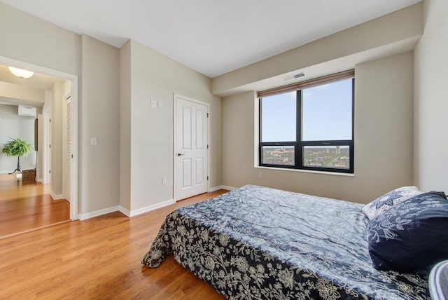 bedroom with wood-type flooring