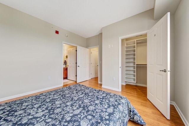 bedroom featuring hardwood / wood-style floors, a closet, and a walk in closet