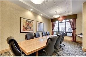 carpeted office featuring a drop ceiling