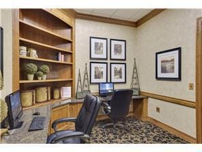 office space featuring ornamental molding and built in desk