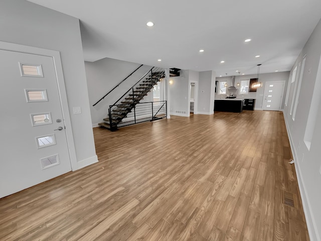 1447 Juliet Ave, Saint Paul, MN 55105 - unfurnished living room featuring light wood-style flooring, stairway, recessed lighting, and baseboards