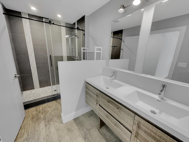 1447 Juliet Ave, Saint Paul, MN 55105 - bathroom with a stall shower, double vanity, and wood finished floors
