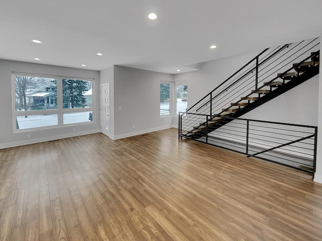 1447 Juliet Ave, Saint Paul, MN 55105 - unfurnished living room with light wood-style flooring, baseboards, recessed lighting, and stairs