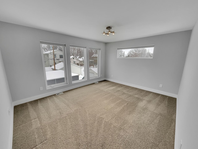 1447 Juliet Ave, Saint Paul, MN 55105 - carpeted spare room with healthy amount of natural light, a chandelier, and baseboards