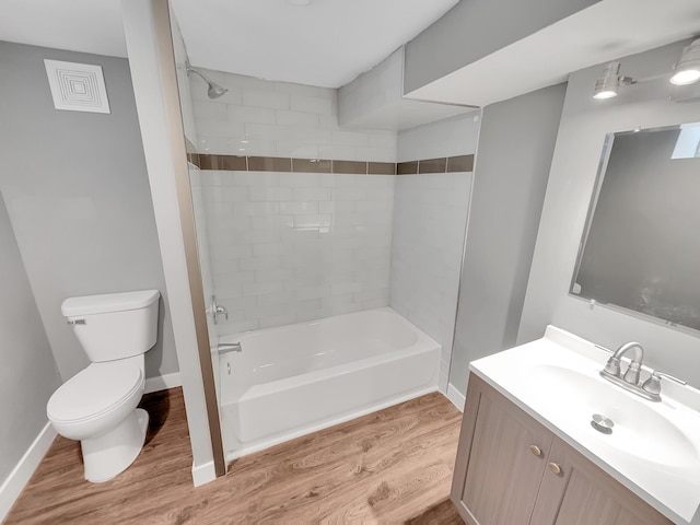 1447 Juliet Ave, Saint Paul, MN 55105 - full bathroom with toilet, vanity, wood finished floors, bathtub / shower combination, and baseboards