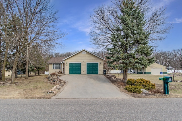 ranch-style home with a garage and driveway