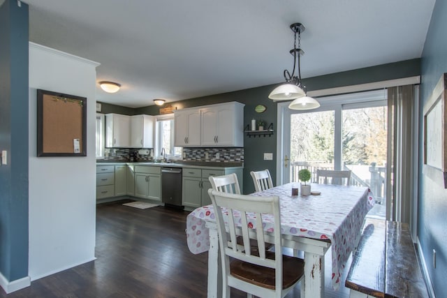 dining room featuring baseboards and dark wood-style floors