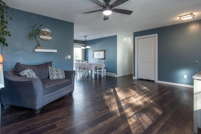 living area featuring ceiling fan, wood finished floors, and baseboards