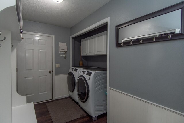 laundry area with washer and dryer, dark wood-style flooring, cabinet space, and a wainscoted wall