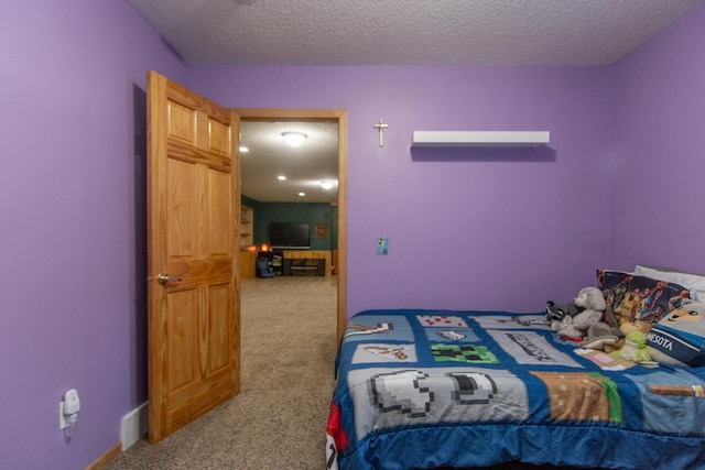 carpeted bedroom with a textured ceiling