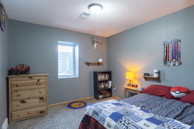 bedroom with visible vents, baseboards, carpet flooring, and a textured ceiling