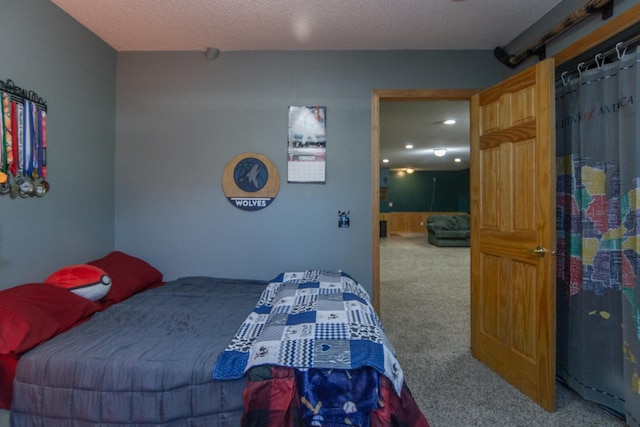 carpeted bedroom featuring a textured ceiling