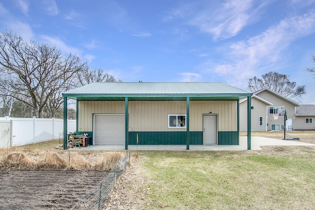 view of outdoor structure with fence and an outbuilding